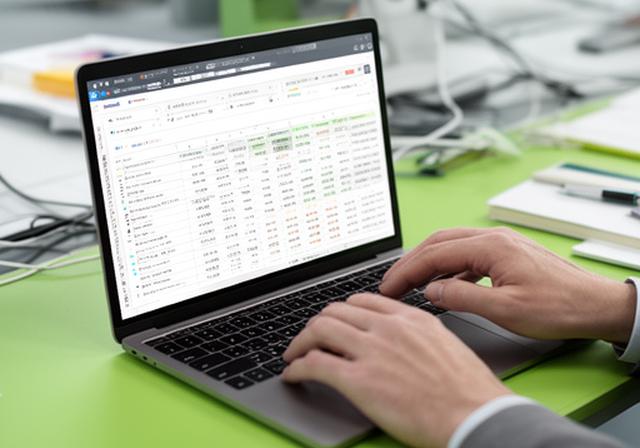 Analyst comparing a spreadsheet and a SQL dashboard on a bright work desk with a laptop open